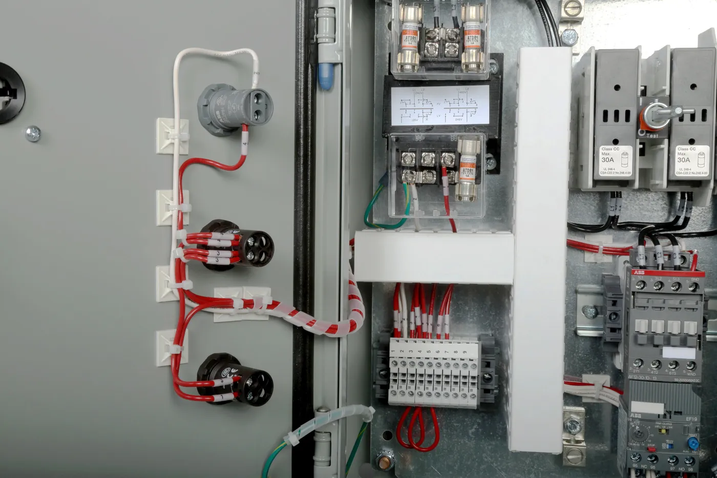 Inside a starter panel: control transformer with fuses, terminal blocks, fuse disconnect, contactor and overload relay